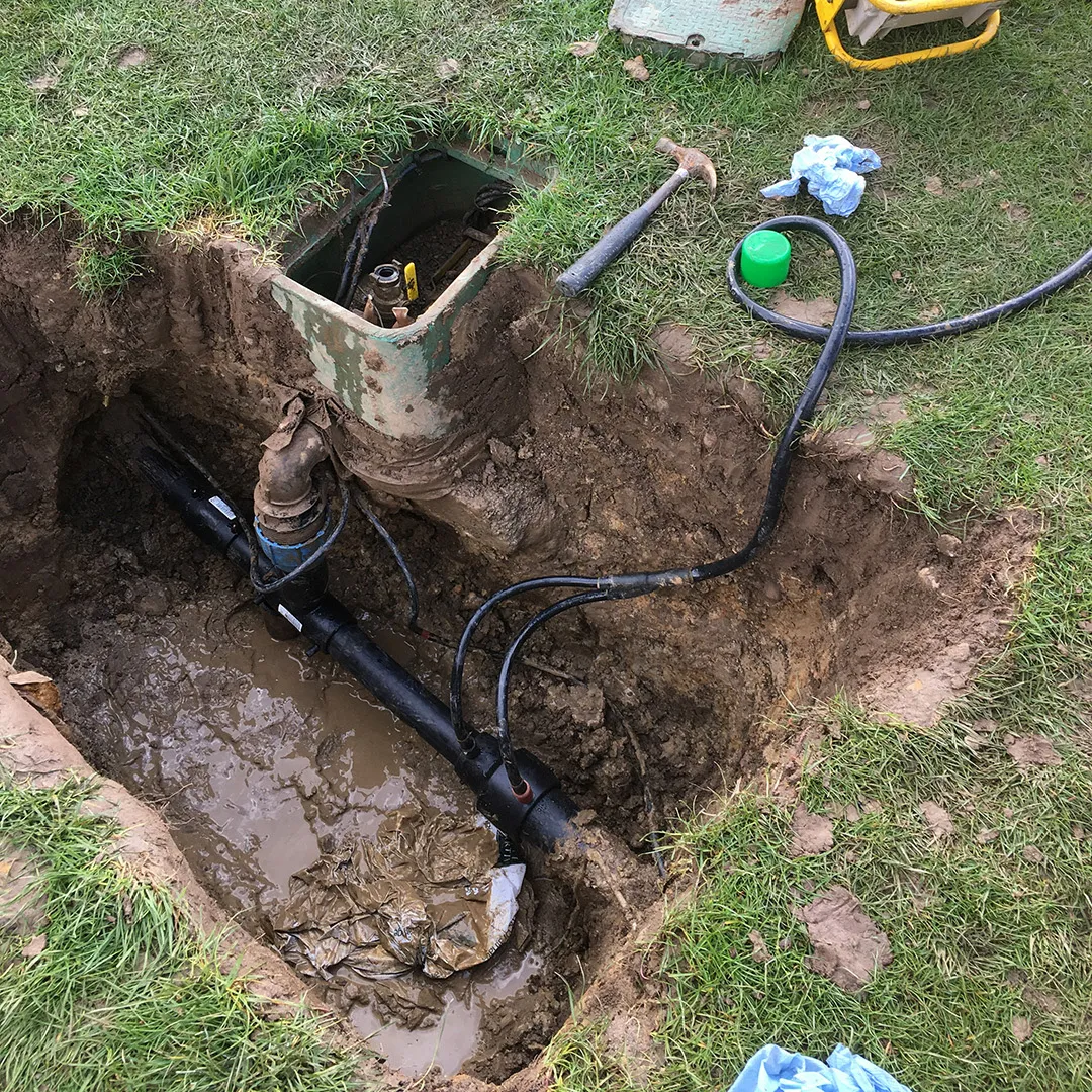 a hole in the ground with a hose connected to it