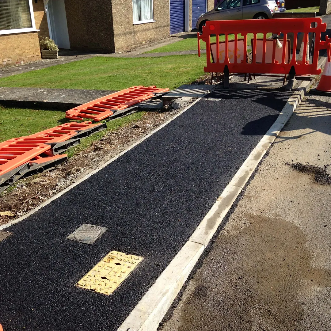 a red bench sitting on the side of a road
