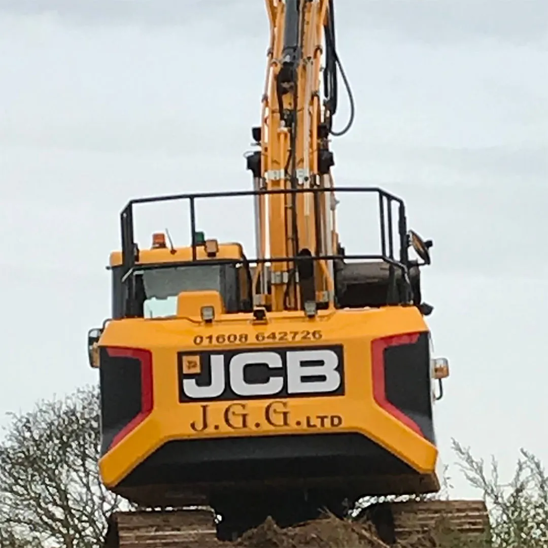 a large yellow and black machine on a dirt field