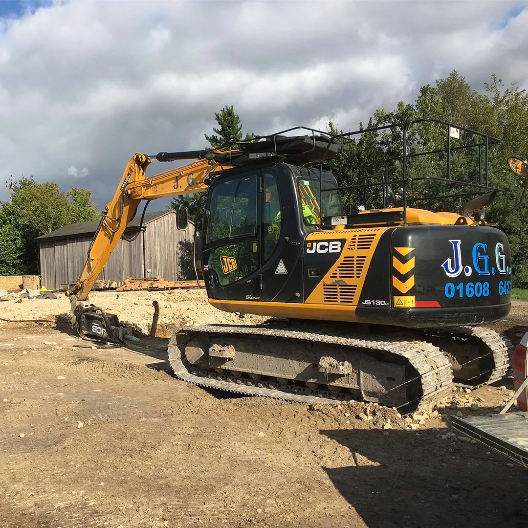 a yellow and black bulldozer on a dirt road