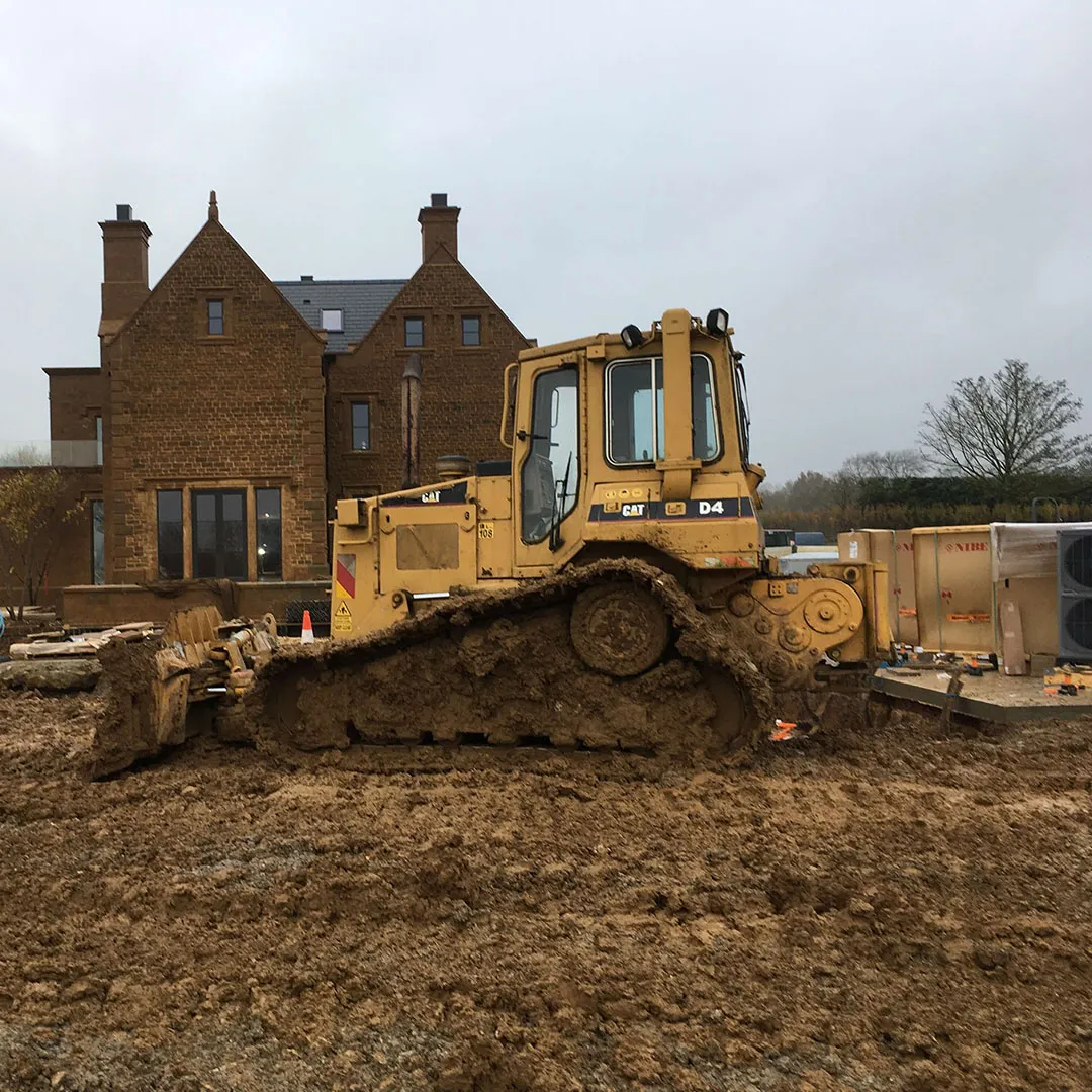 a bulldozer is parked in front of a house