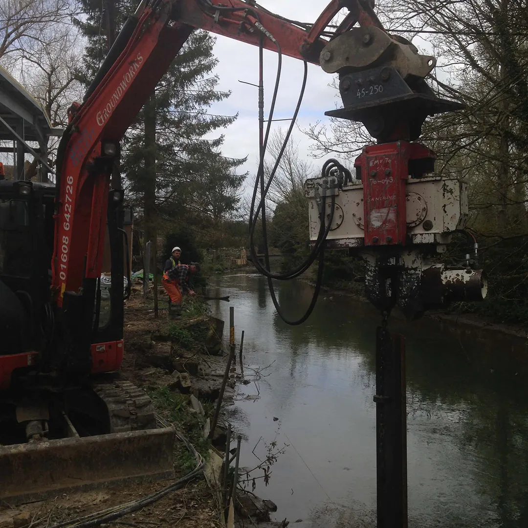 a crane is lifting a piece of equipment into the water