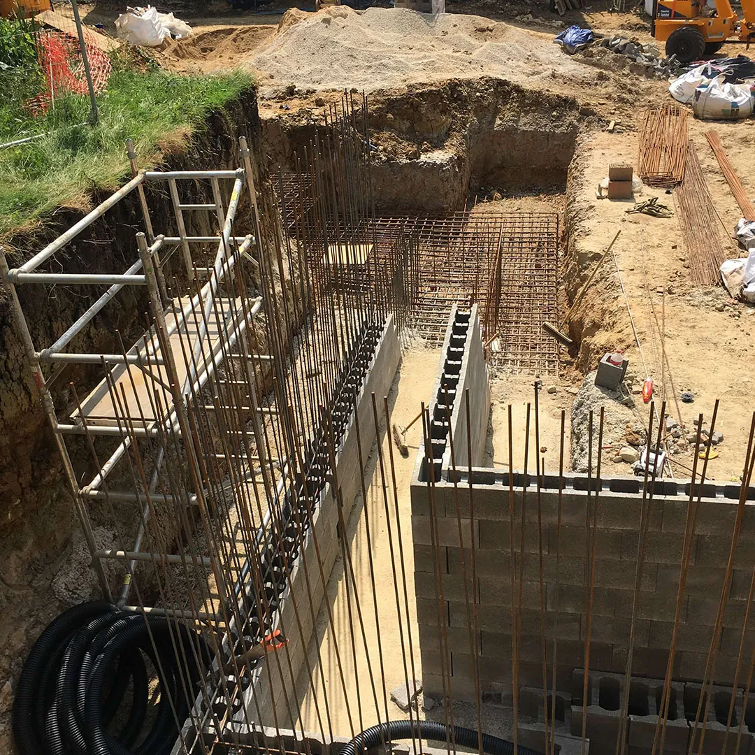 a building under construction with a crane in the background
