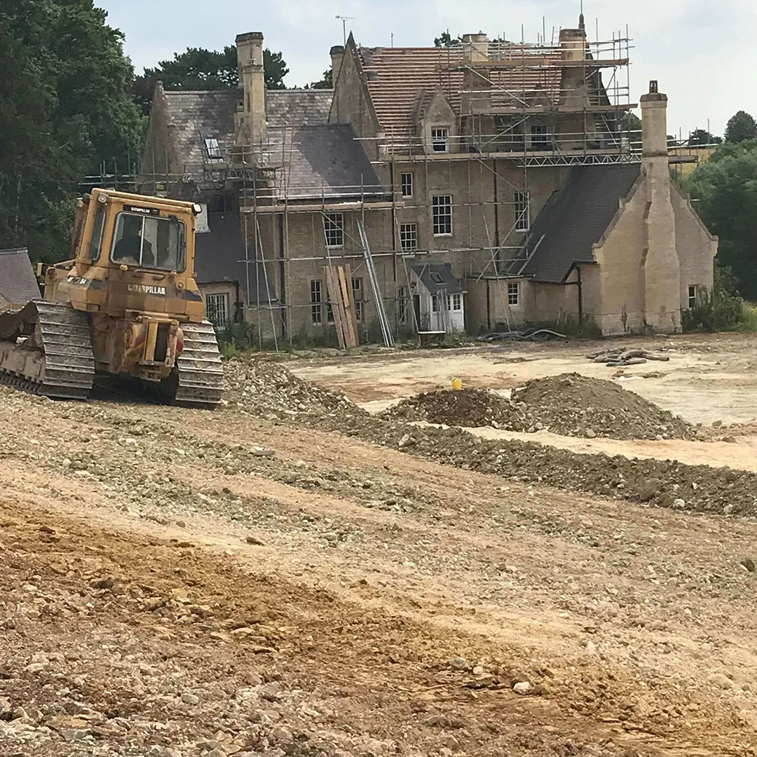 a bulldozer is parked in front of a house
