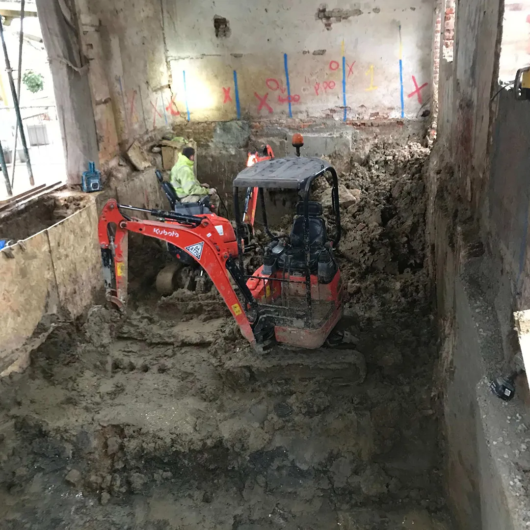 a construction site with a small tractor in the middle of it
